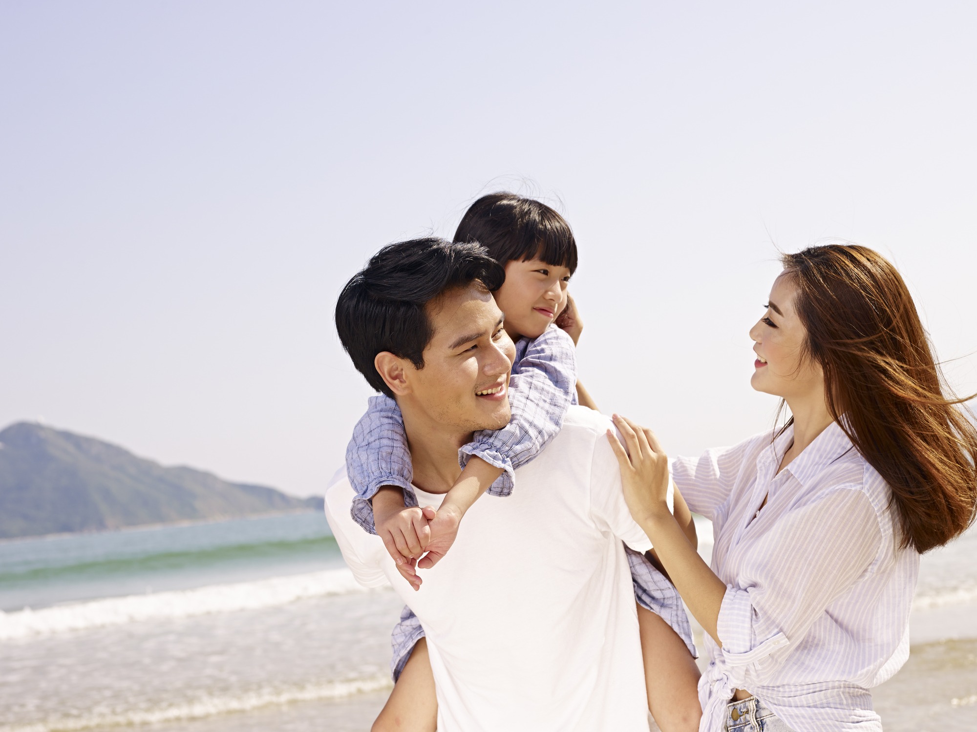 happy asian family having fun on beach.